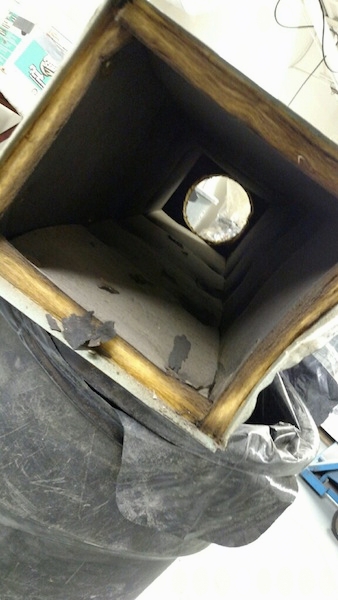 An AC and heat duct lined with fiberglass on the inside of the duct with a dry rotted paper lining