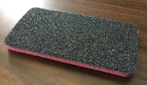 A large rectangular black and pink nail file board for dogs