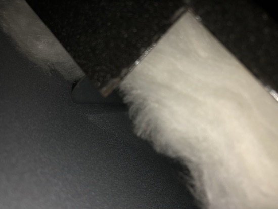 Close up of exposed white ceramic fiber wool inside of a household oven.